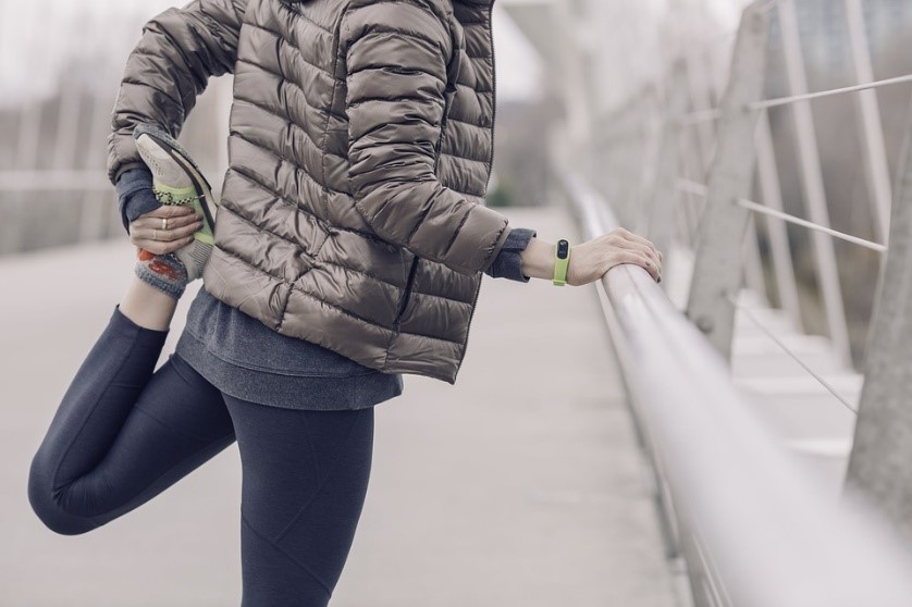 woman stretching outside in the cold